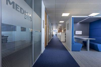 Blue carpeted office hallway 