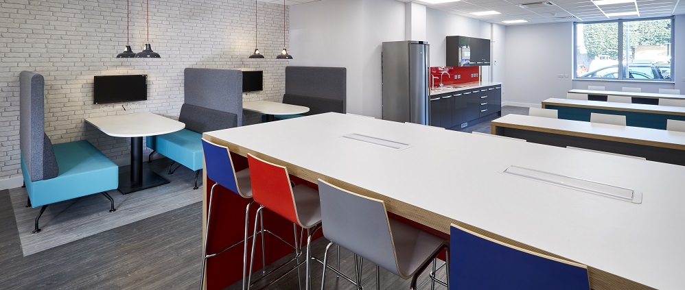 high table with curved seat bar stools in a staff breakout area