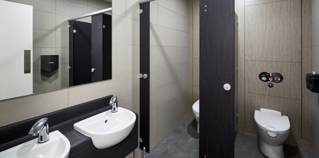 staff washroom containing 2 toilet cubicles with self-flush and 2 hand basins